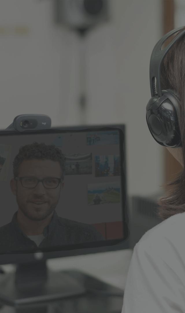 Coworker in online meeting using a webcam from Logitech